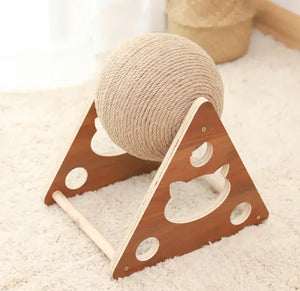 Wooden cat toy with a spherical rope ball on a light carpet