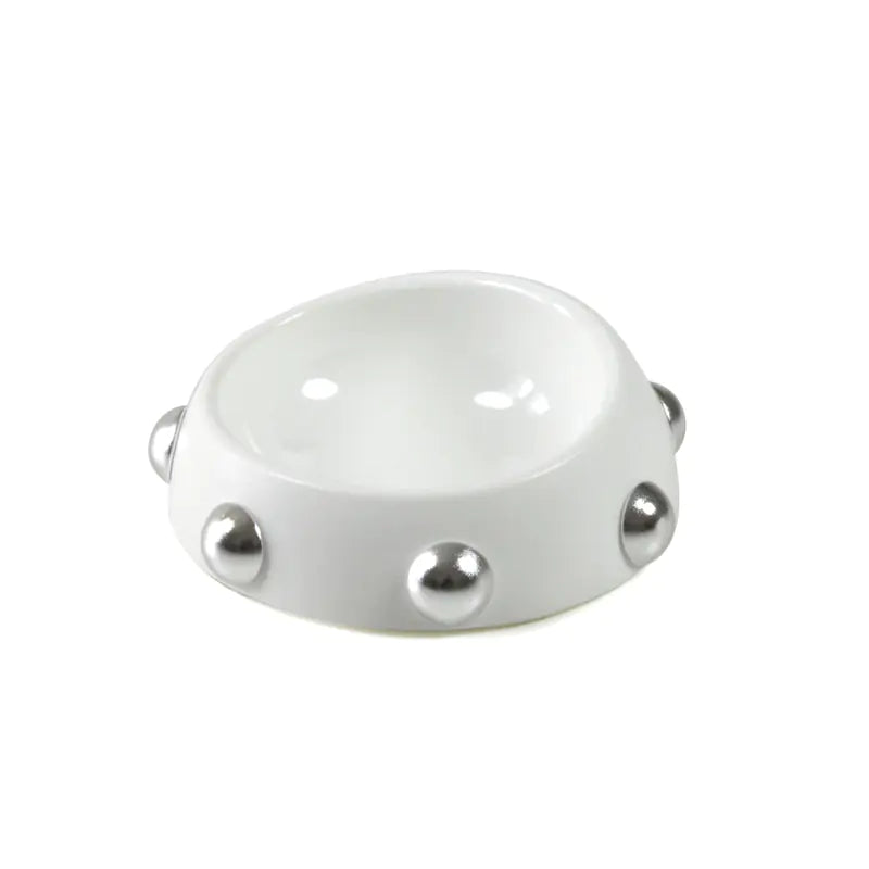 White ceramic bowl with silver embellishments on a white background