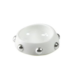 White ceramic bowl with silver embellishments on a white background
