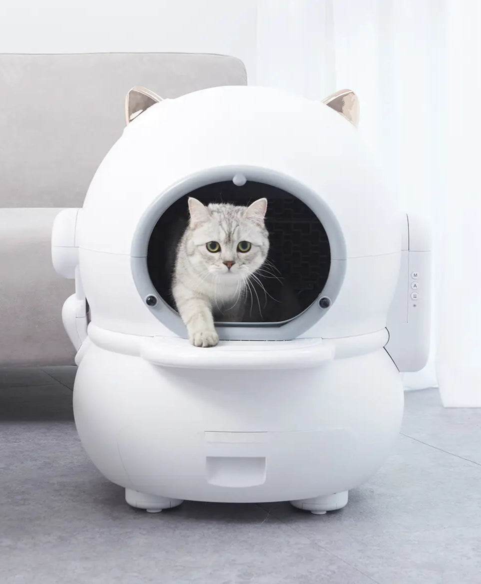 White pet house shaped like a helmet with a cat inside on a light gray floor.