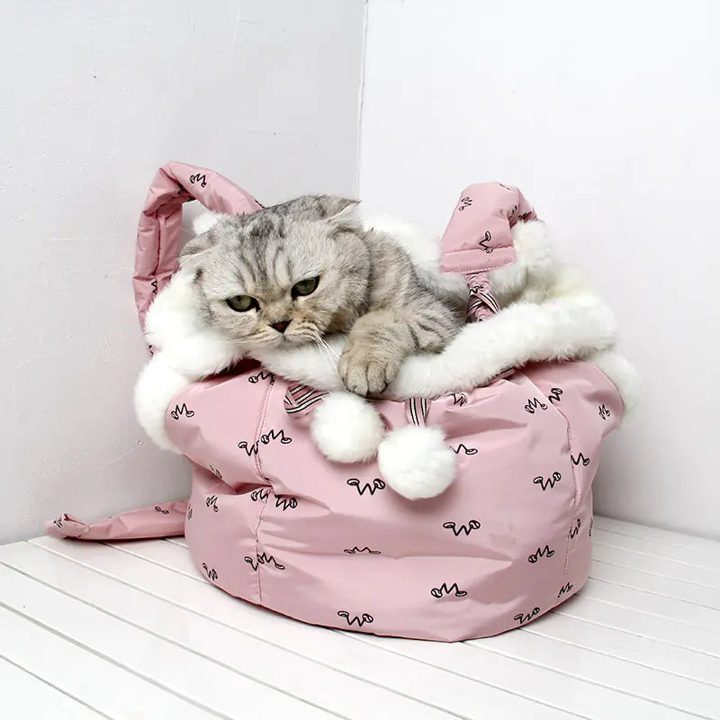 Cat inside a pink pet carrier with white fur on a white floor.