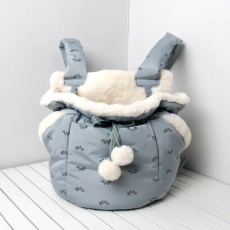 blue pet carrier with white fur