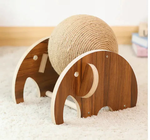 Wooden elephant-shaped toy with a sisal ball on a soft surface