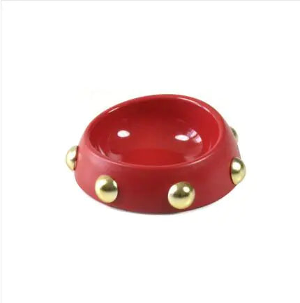 Red bowl with gold embellishments on a white background