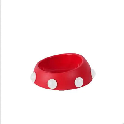 Red bowl with white polka dots on a white background