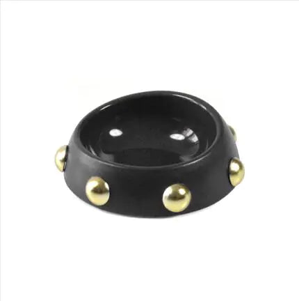 Black bowl with gold studs on a white background