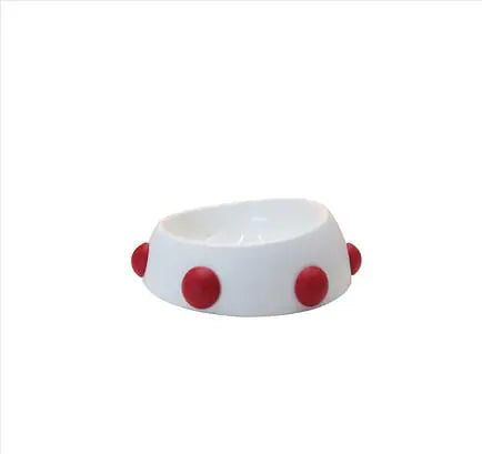 White bowl with red polka dots on a white background