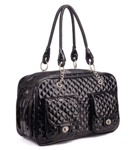 Black quilted handbag with braided handle on a white background