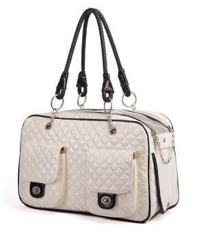 White quilted handbag with black accents on a white background