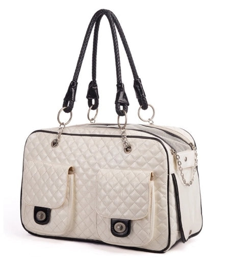 White quilted handbag with black accents on a white background
