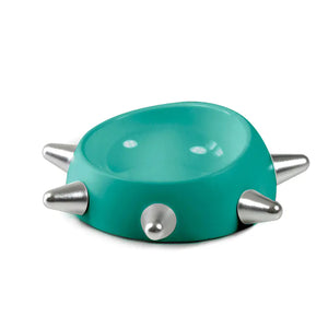 Turquoise bowl with silver spikes on a white background
