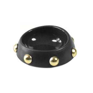 Black bowl with gold studs on a white background