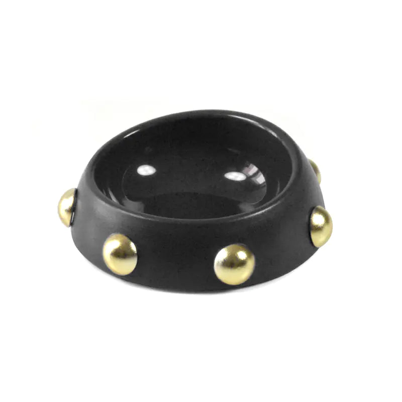 Black bowl with gold studs on a white background
