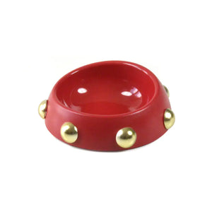 Red bowl with gold studs on a white background