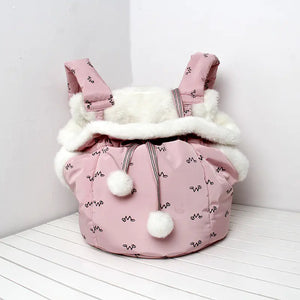 Pink pet carrier with white fur on a white background
